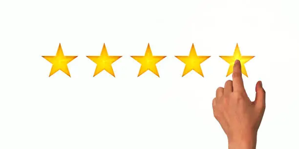 Photo of A woman clicks on a star rating, the concept of a positive rating, reviews and feedback. White background