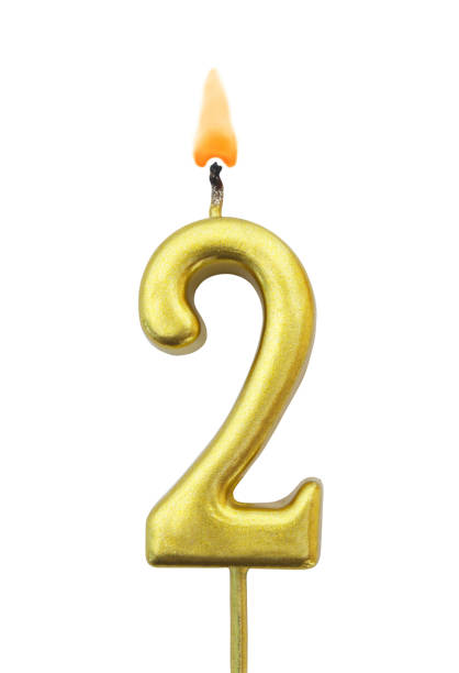 istock Golden birthday candle isolated, number 2 1175025228