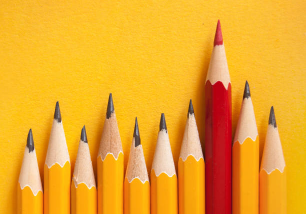 istock Red pencil amongst orange 1175026784