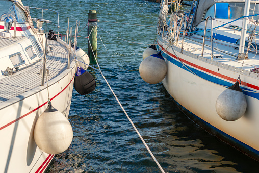 Fenders protecting two boats from each other at quay