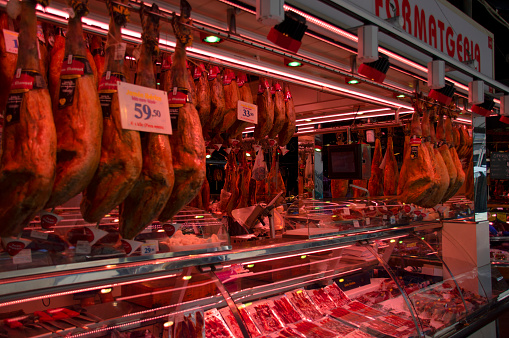 2017, Barcelona, Spain. Ham shop at the historical La Boqueria market in Barcelona, Spain. La Boqueria is one of the main tourist attractions in the city. Jamon Iberico, Serrano Prosciutto, Iberic Bacon.