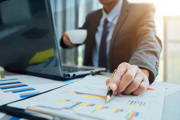 istock Business people partner negotiating a contract, they are pointing on a document and discussing together,Two businessmen are negotiating in office. 1175030351