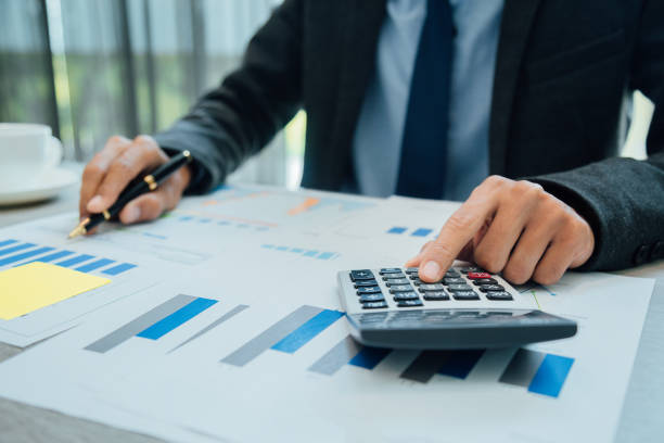 istock Business people partner negotiating a contract, they are pointing on a document and discussing together,Two businessmen are negotiating in office. 1175030652
