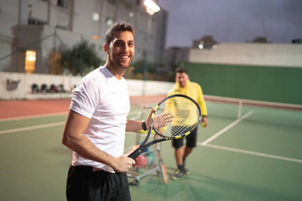 istock Teaching a guy how to play tennis 1175030729