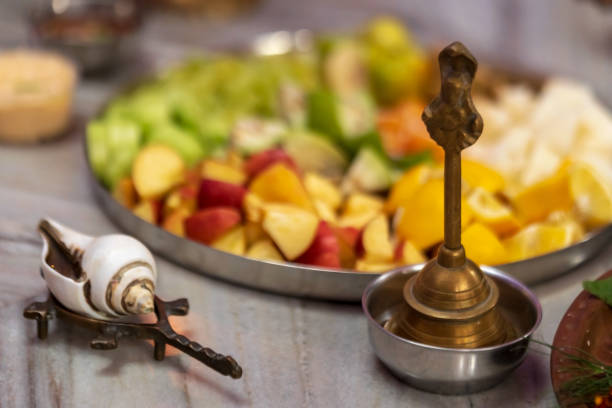 Puja Ritual Preparations Background concept for durga puja preparations. Shankha, Brass Bell, A plate full of fruits, prasad for indian hindu festival rituals. indian goddess lakshmi stock pictures, royalty-free photos & images