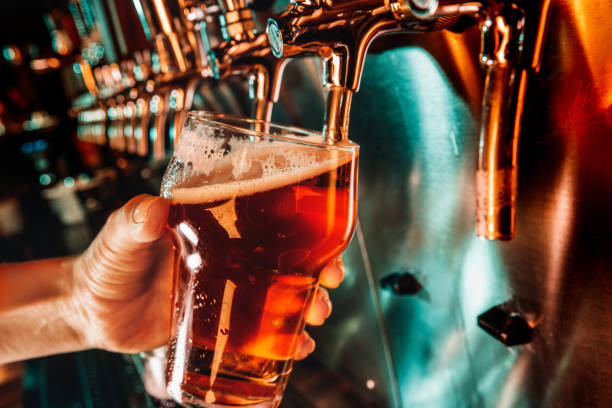 istock Hand of bartender pouring a large lager beer in tap 1175032093
