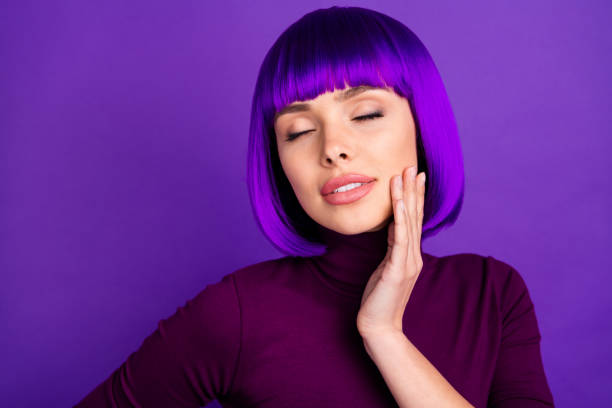 close up photo of peaceful dreamy youth with her eyes closed wearing violet purple background - bangs fashion model women elegance imagens e fotografias de stock