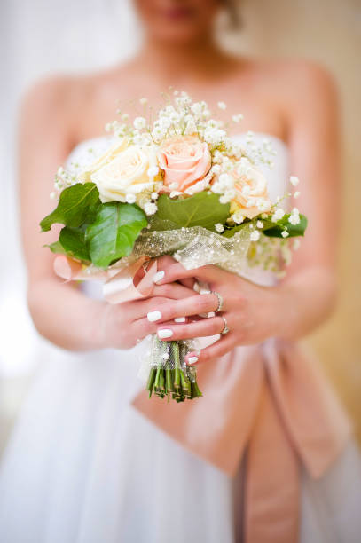 istock bride holds her bouquet in her arms, close-up 1175034348