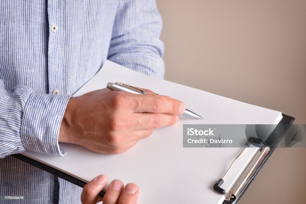 Folder Note Taking Man Taking Notes In A Folder Elevated View Stock Photo - Download Image ...