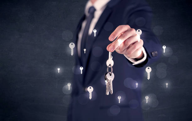 istock Businessman holding keys with keys around 1175037436