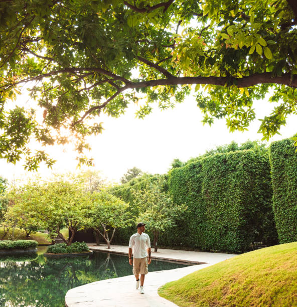 istock stylish man walking in a garden 1175037638