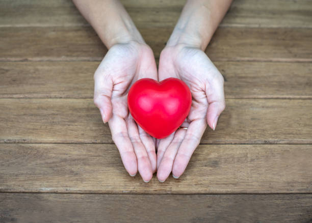 istock Hand holding Heart shape on wooden background 1175038391