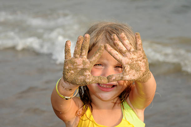 Girl with Sandy Hands stock photo