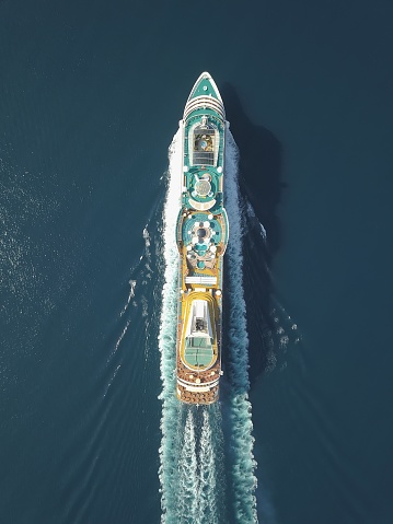 Aerial view large cruise ship at sea, Passenger cruise ship vessel, sailing across the Ksamil, Albania. View from drone.