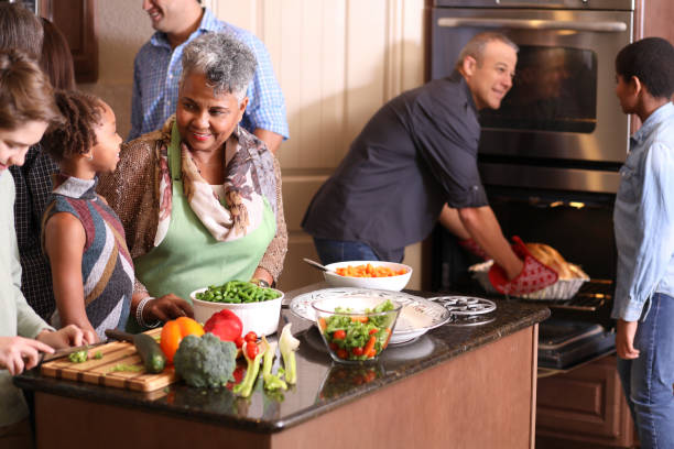 istock Diverse family in home kitchen cooking Thanksgiving dinner. 1175039958