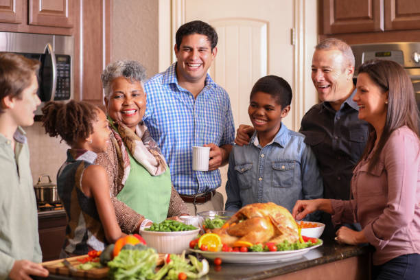 istock Diverse family in home kitchen cooking Thanksgiving dinner. 1175040024