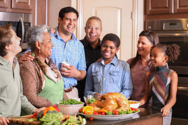 istock Diverse family in home kitchen cooking Thanksgiving dinner. 1175040047