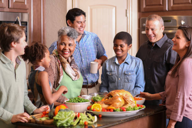 istock Diverse family in home kitchen cooking Thanksgiving dinner. 1175040083