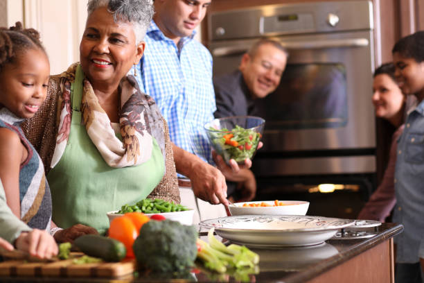 istock Diverse family in home kitchen cooking Thanksgiving dinner. 1175040216
