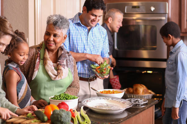 istock Diverse family in home kitchen cooking Thanksgiving dinner. 1175040238