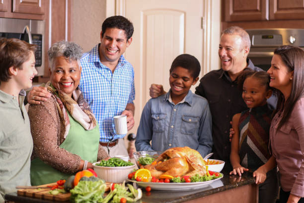 istock Diverse family in home kitchen cooking Thanksgiving dinner. 1175040474