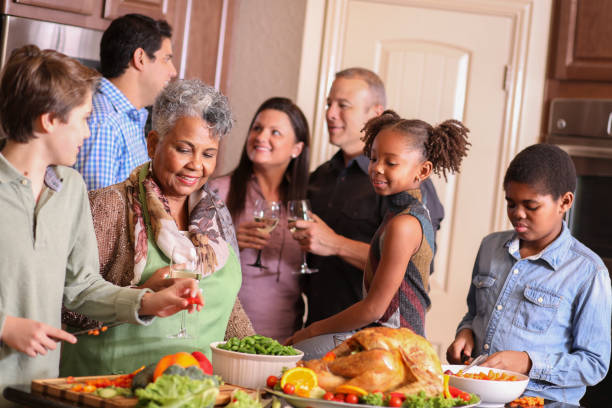 istock Diverse family in home kitchen cooking Thanksgiving dinner. 1175040502