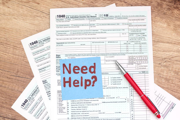 istock Tax form with pen on wooden background 1175040522
