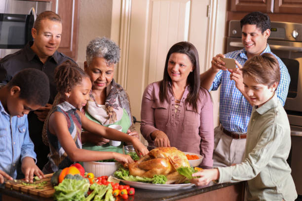 istock Diverse family in home kitchen cooking Thanksgiving dinner. 1175040558
