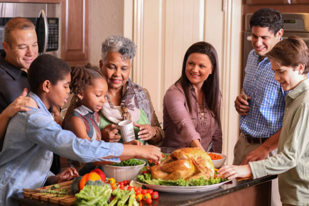 istock Diverse family in home kitchen cooking Thanksgiving dinner. 1175040611