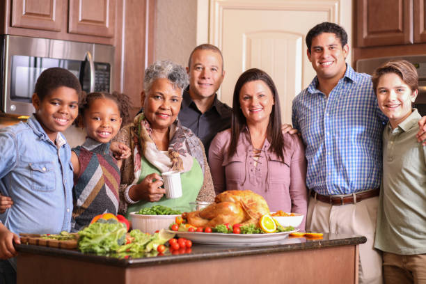 istock Diverse family in home kitchen cooking Thanksgiving dinner. 1175040646