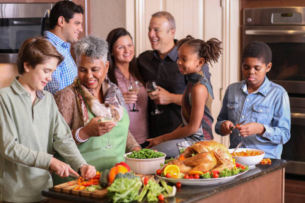 istock Diverse family in home kitchen cooking Thanksgiving dinner. 1175041290