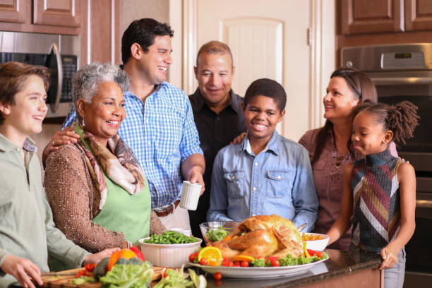istock Diverse family in home kitchen cooking Thanksgiving dinner. 1175041351