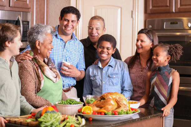 istock Diverse family in home kitchen cooking Thanksgiving dinner. 1175041373