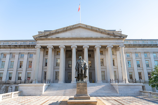 Washington, DC -January 26, 2024: The exterior of the Smithsonian Institution Museum of Natural History. Petrified wood is displayed on a platform on front of the museum.