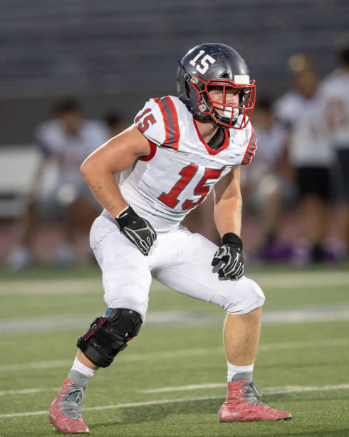 istock Young Boy Playing High School Tackle Football 1175043668