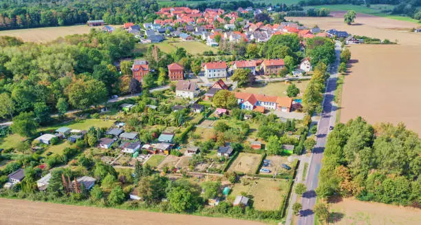 Photo of Aerial view of a village with a garden plot