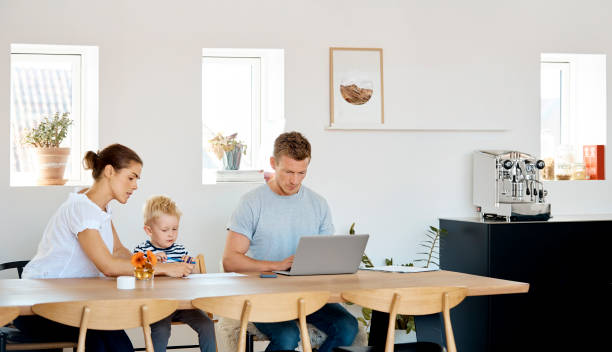 istock Mother and son drawing by father using laptop 1175046312