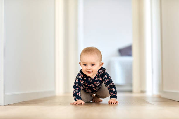 istock Cute baby boy crawling in corridor at home 1175046406