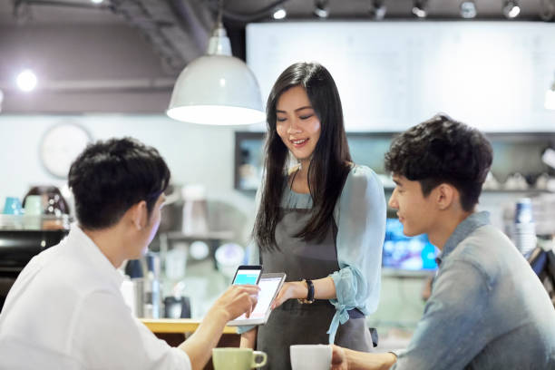 istock Young men doing contactless payment to barista 1175049299