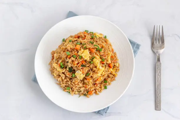 Chinese / Asian Egg and Vegetable Fried Rice on a White Plate on the White Background Directly Above Photo.