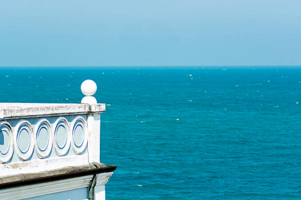 Ancient house with a decorated balcony overlooking the sea. Architecture and holidays.