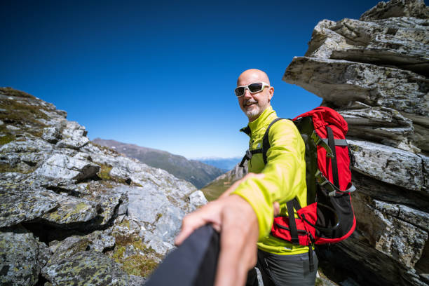istock friendly hiking guide giving a helping hand outdoors in mountains 1175050167