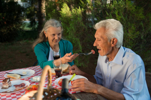 istock Woman feeding man on a picnic 1175050587