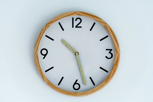 traditional clock on white wall background isolated close up