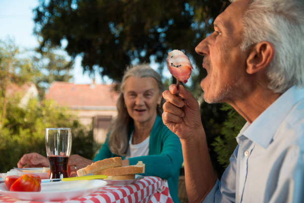 istock Cheerful senior couple having fun on a picnic 1175050798