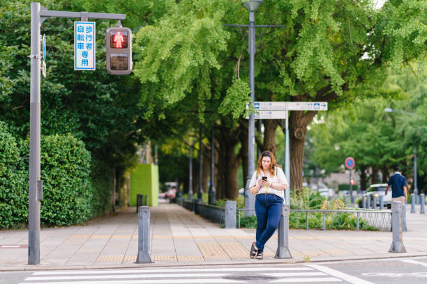 istock Young happy woman using smart phone in city 1175052215