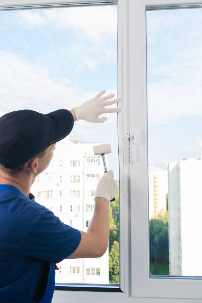 istock plastic window installation wizard fastens glass with a rubber mallet 1175052333