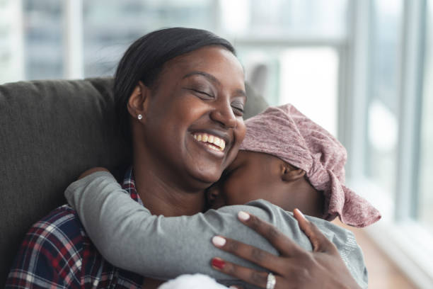 istock Supportive mother holds child with cancer 1175052366