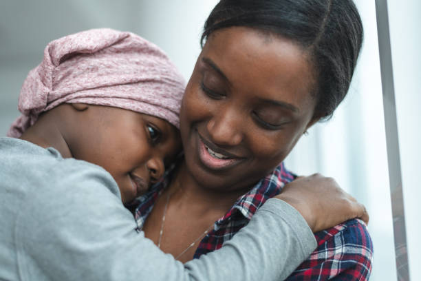 istock Supportive mother holds child with cancer 1175052380