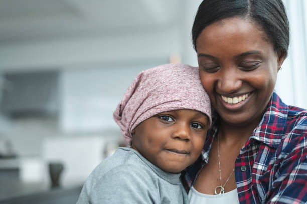istock Supportive mother holds child with cancer 1175052399